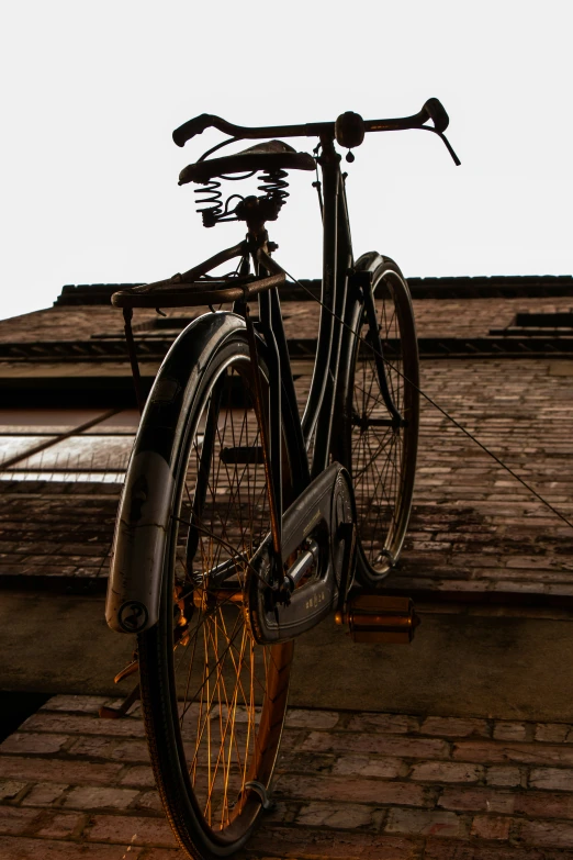 a bike sits on the sidewalk against a wall