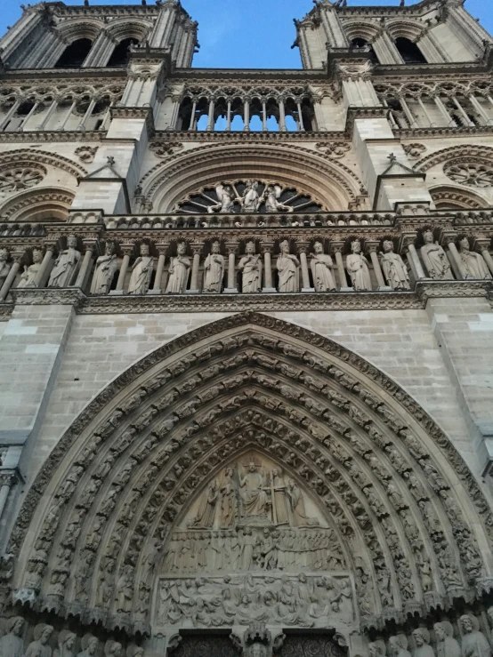 two towers of a large building with statues