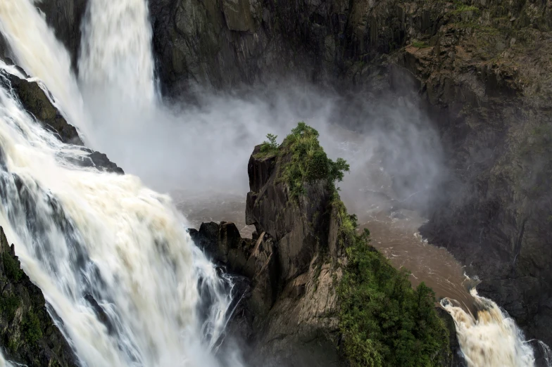 a huge waterfall coming out of the middle of a large body of water