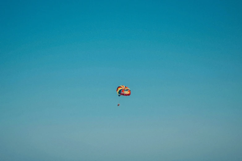 a colorful, flying bird kite can be seen in the sky