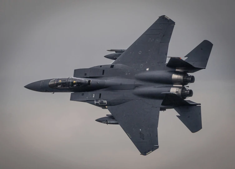 a fighter jet flying through the sky with two engines