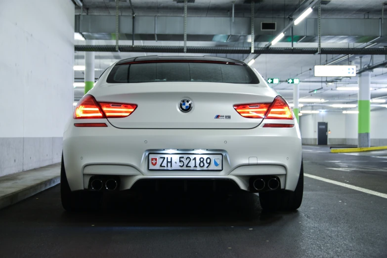 a white bmw with an m performance package on