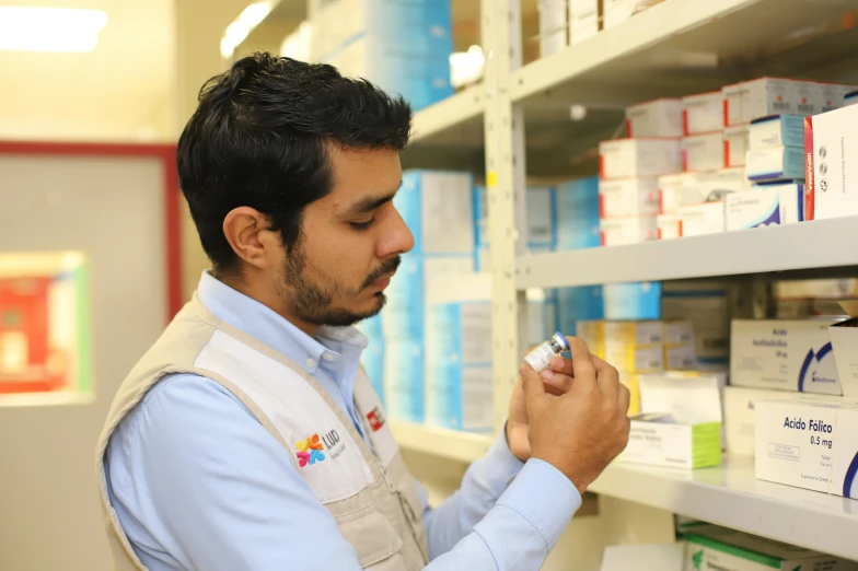 a man is working on soing in a pharmacy