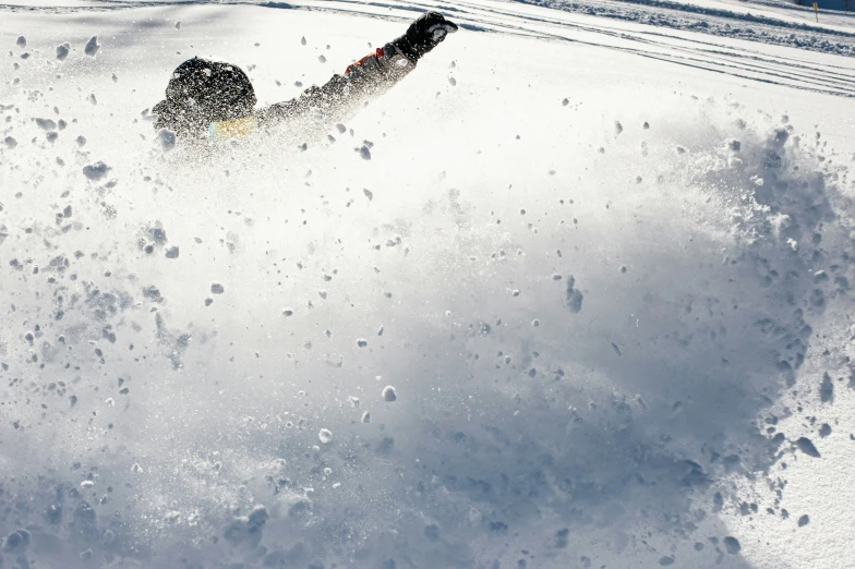 a person in black pants skiing down a snow covered slope