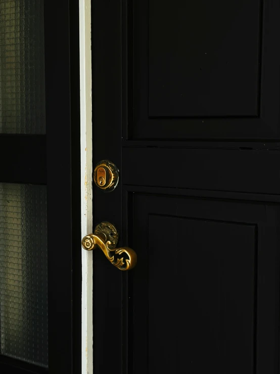 a black door with a ss handle on it