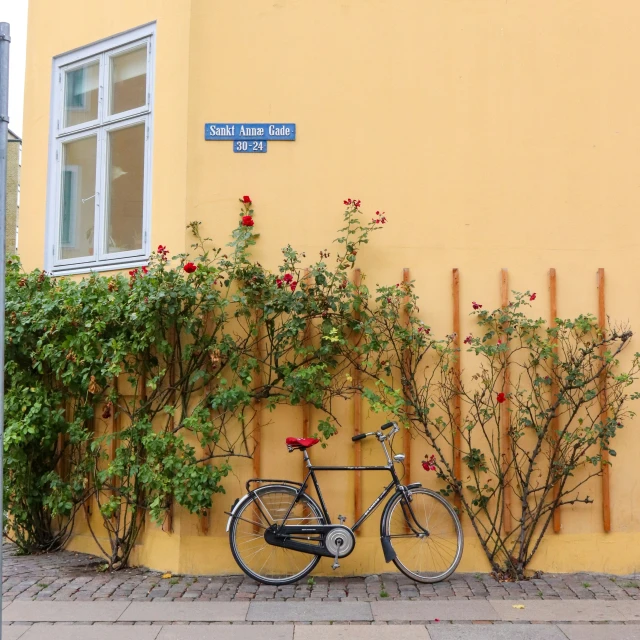 a bike  to the side of a yellow building