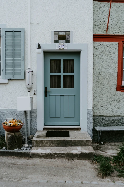 a blue door in front of a white house