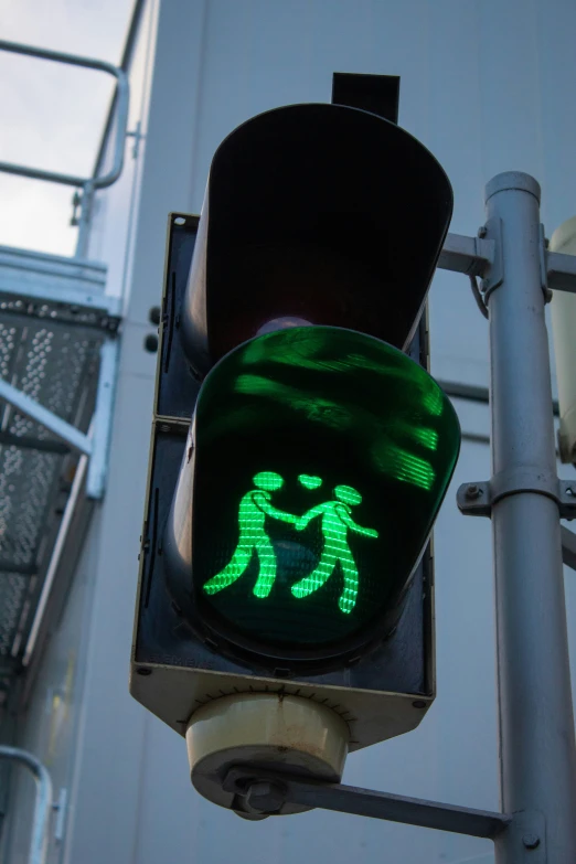 the green traffic light reads it has a picture of a man and a woman walking