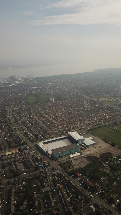 an aerial view of a city with a large soccer field