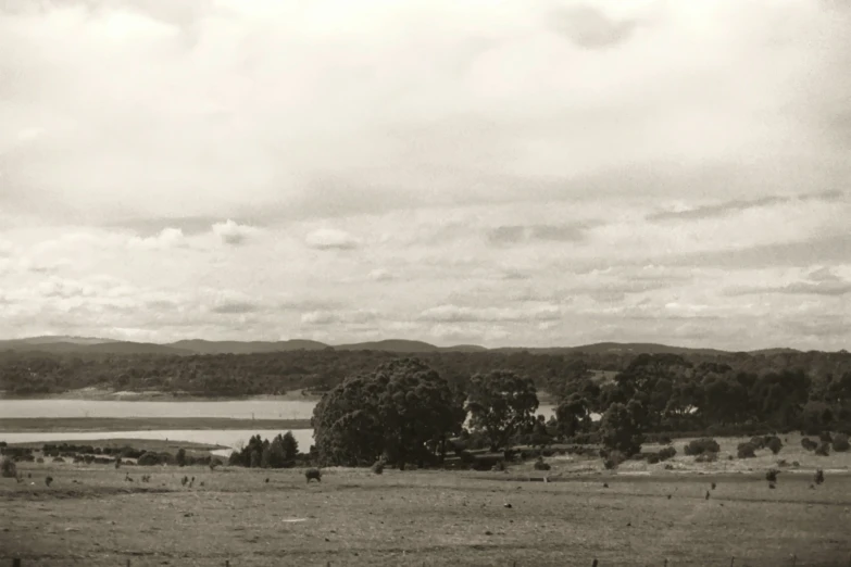 this is an old po of people in a field next to a lake