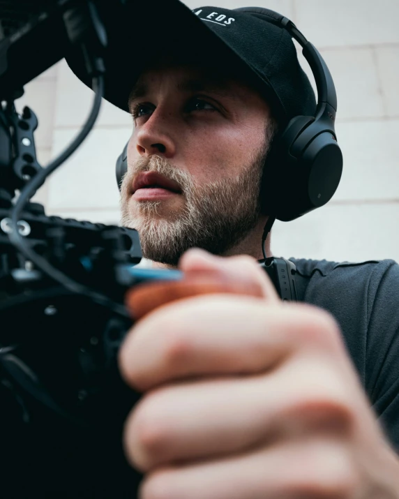 a man in headphones with a microphone is shooting