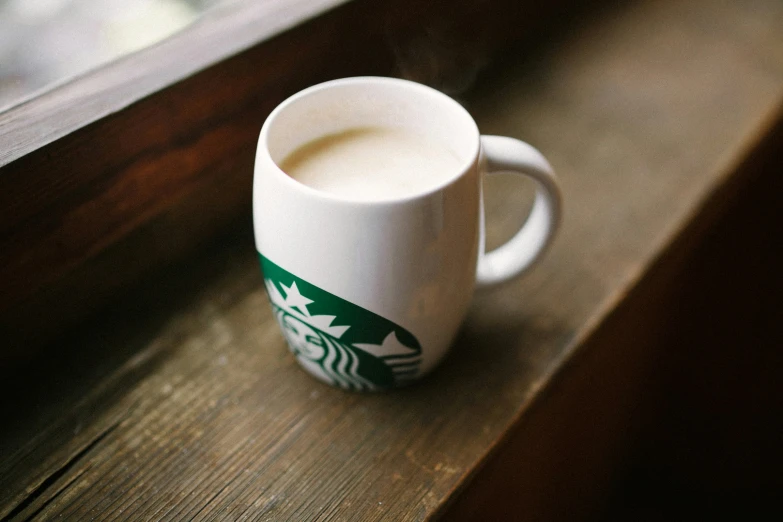 a coffee mug is placed on a window sill