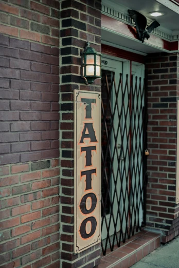 a brick building with a tattoo sign