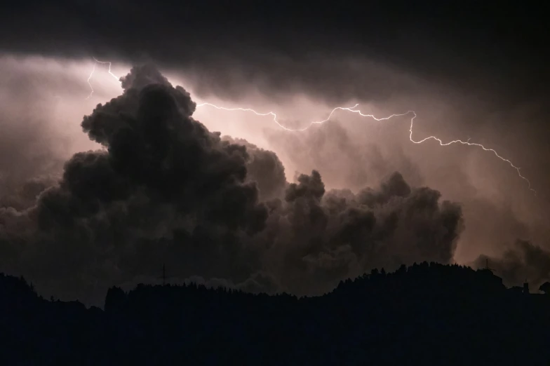 a group of clouds with lightning coming from them