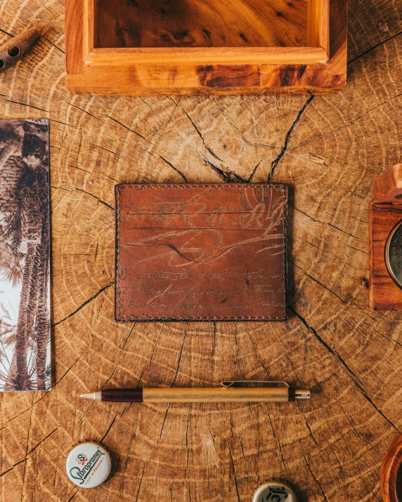 wood with wooden board, leather wallet and pencil