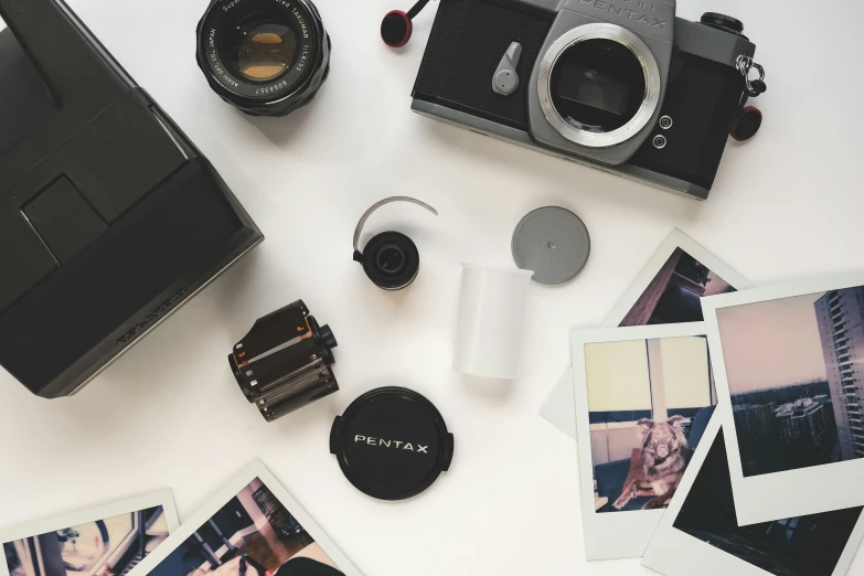 an analog camera sitting on top of a table next to several pos