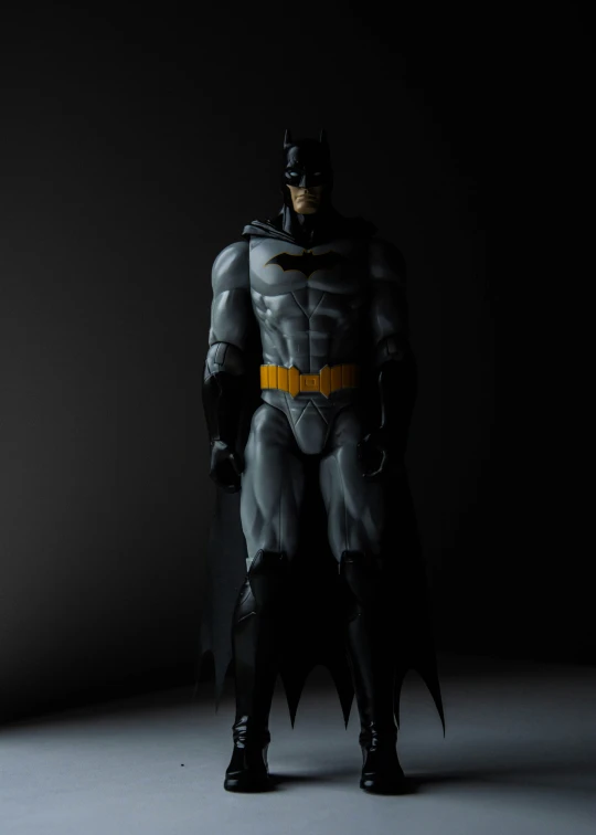 a dark background with a black batman figure on the right side