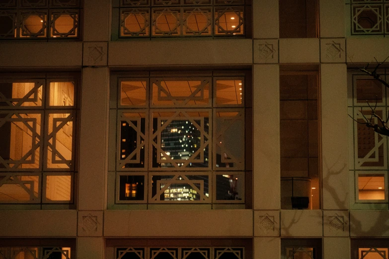 a large window looking up into an illuminated building