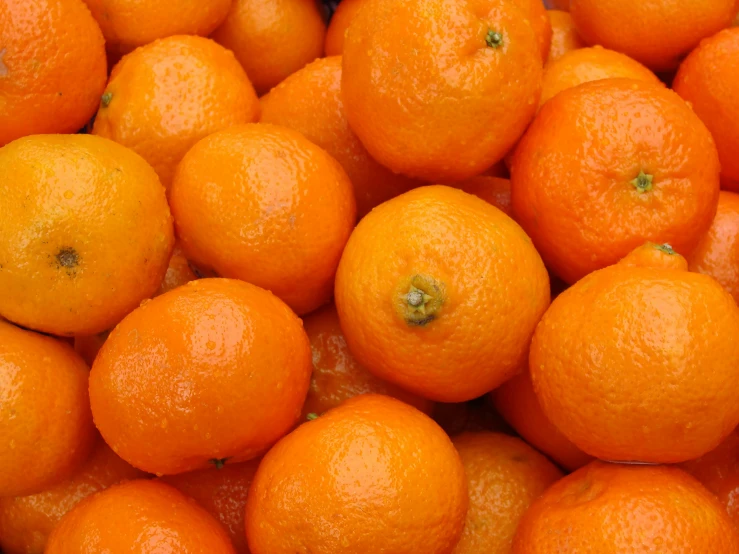 a group of oranges sitting on top of each other