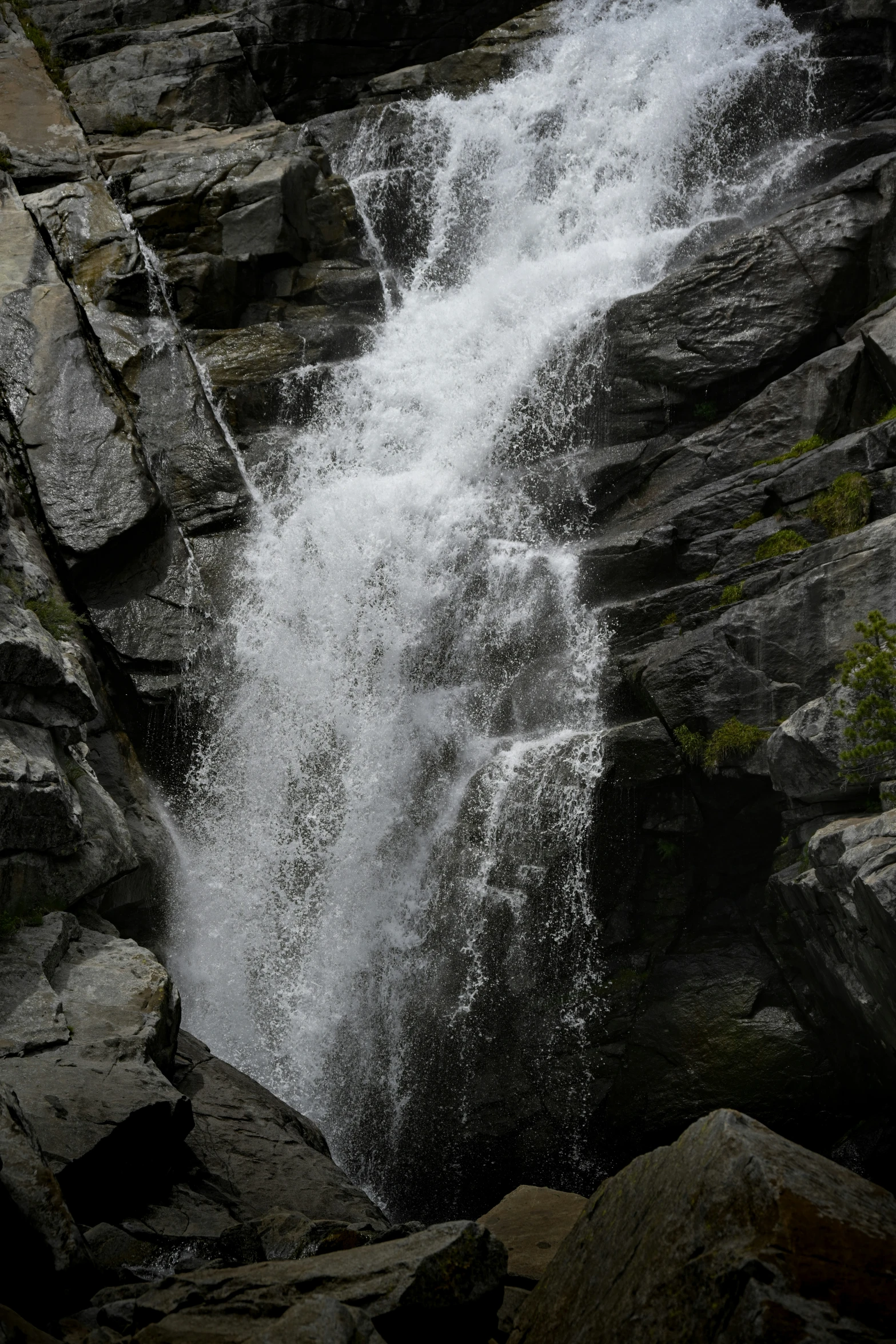 the water is crashing through the rocks near the waterfall