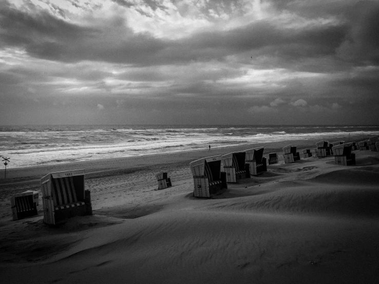 a group of beach chairs sitting on the sand