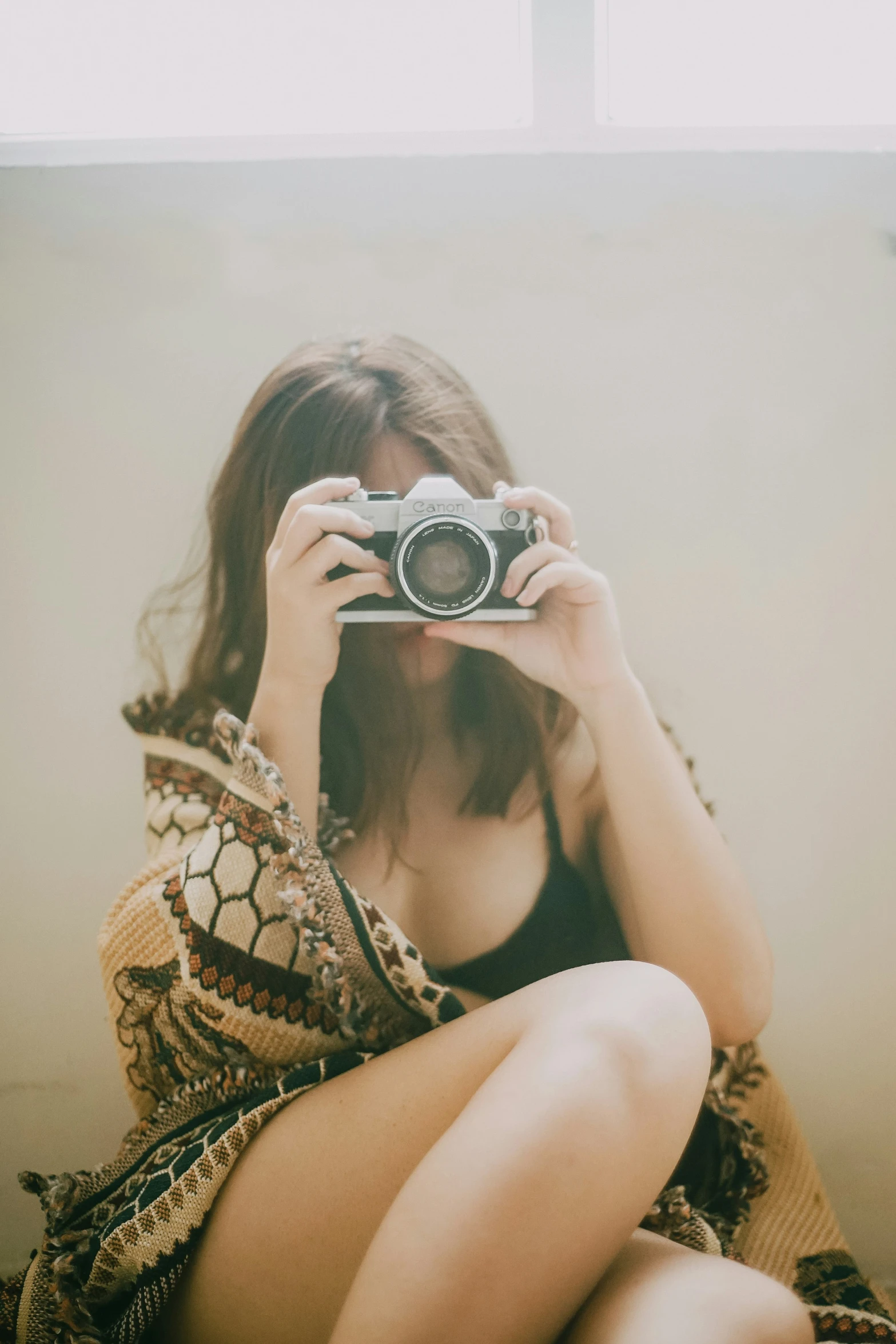 a woman is taking a pograph with a camera