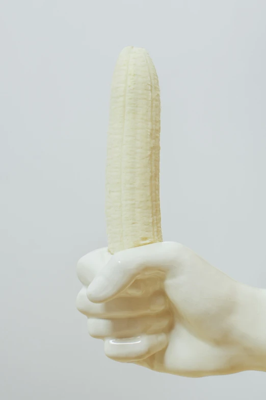 the back side of a banana held in one hand