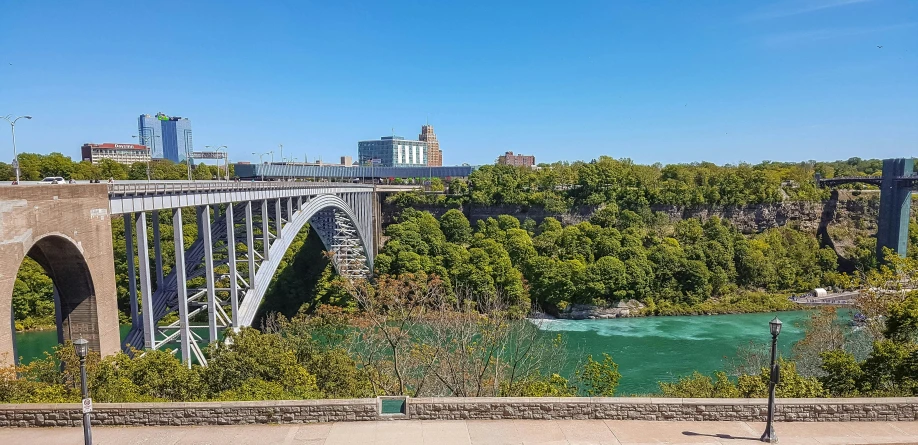 a bridge crosses a river in front of an urban area