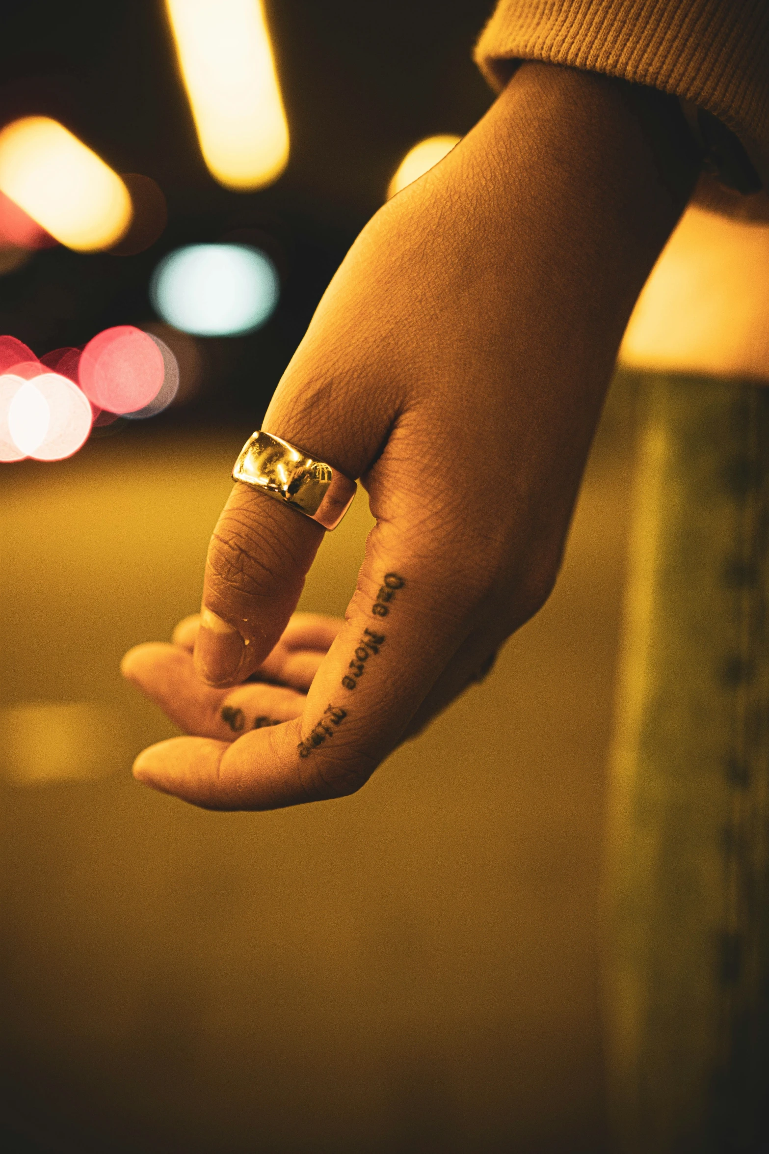 a person with a wedding band is holding on to their hand