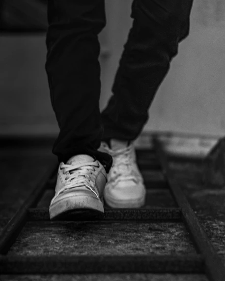 the feet of an object and person on stairs