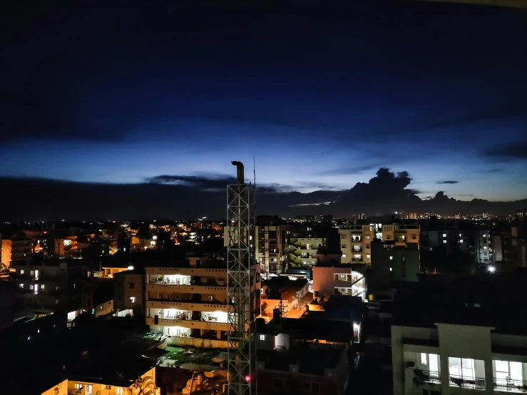 the city lights are on as seen from the roof