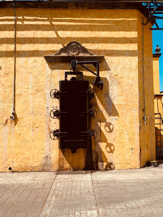 the outside of a building that has an electric transformer on the wall