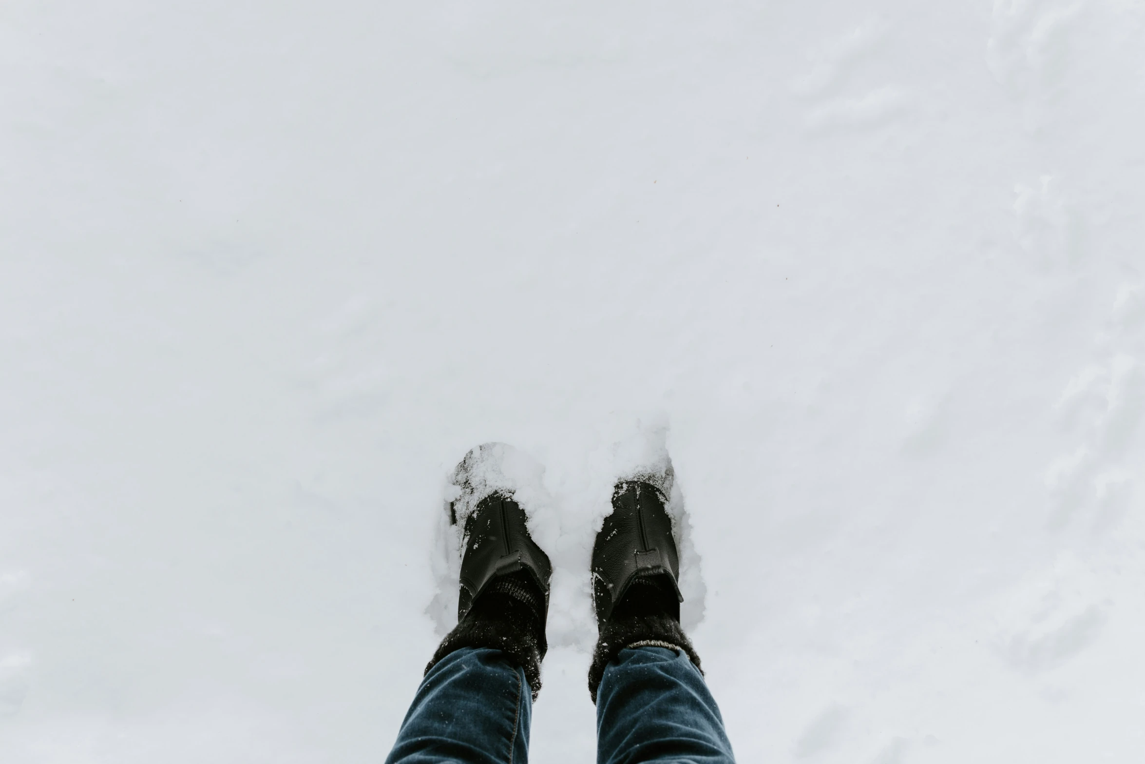 person standing in deep snow surrounded by a cloud