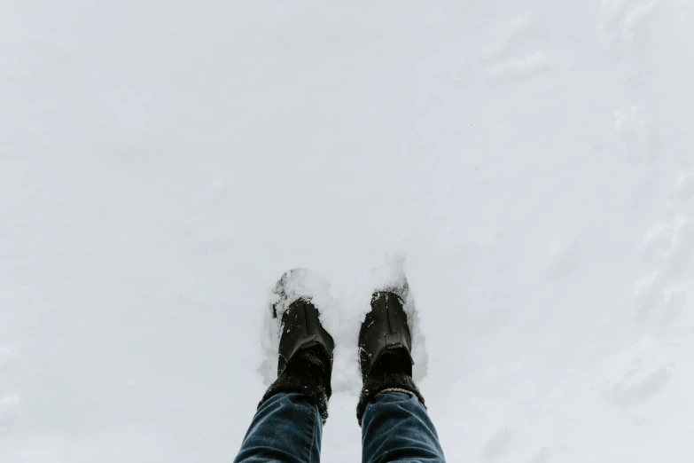 person standing in deep snow surrounded by a cloud