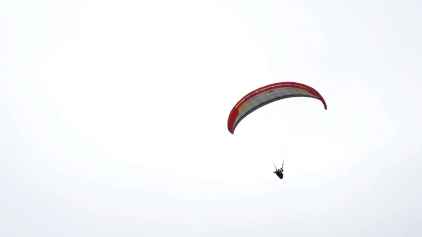 a parachute being flown in the air with it's wings stretched out