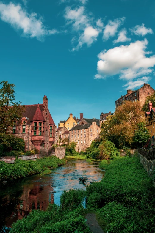 a river and old buildings on the side of a street