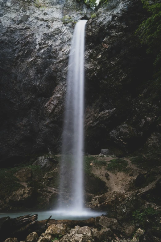 a waterfall rises high into the water below