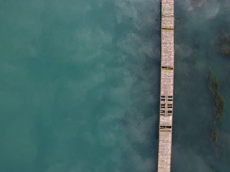 a long wooden dock that is on a body of water