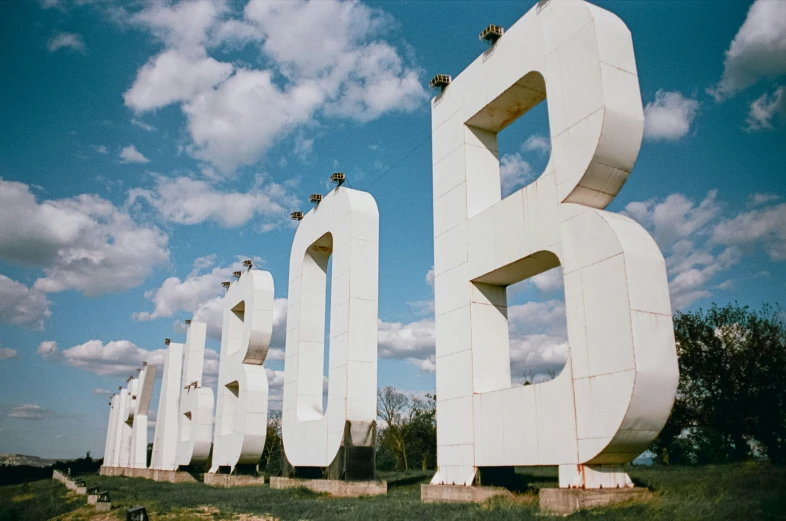 a large set of white letters sitting next to each other on a field