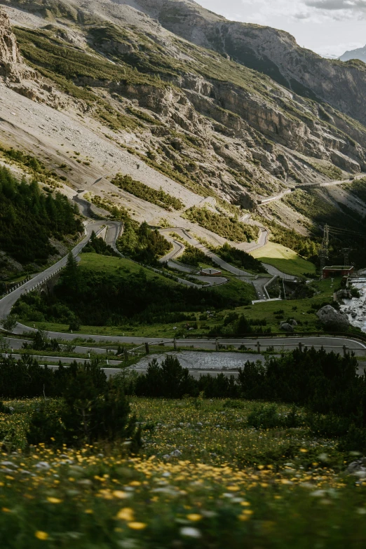 a winding mountain road going down into the distance