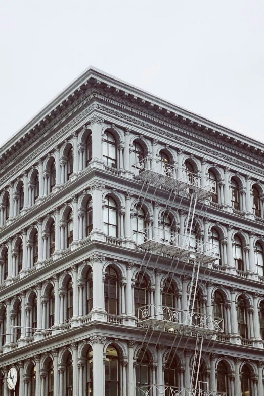 an old looking grey building with lots of windows