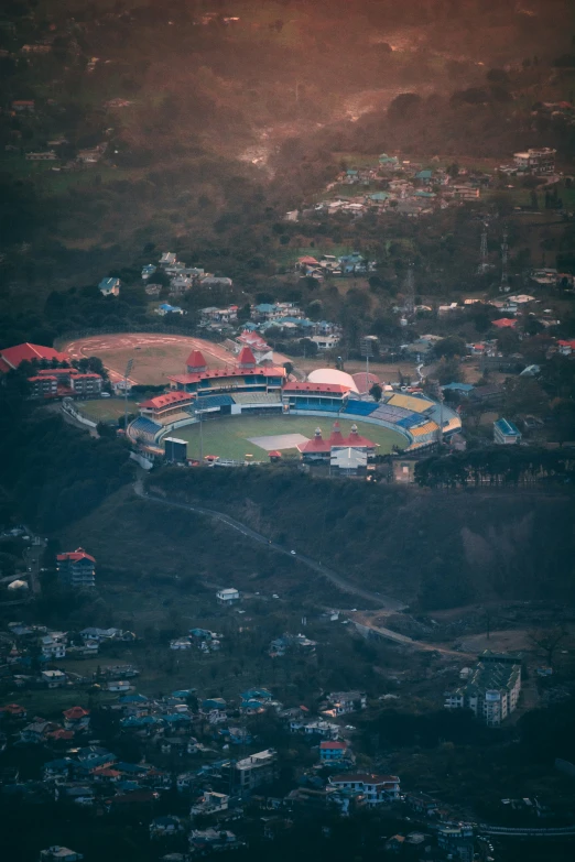 a stadium stands surrounded by a lot of houses