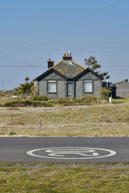 an old house stands alone on a rural country road