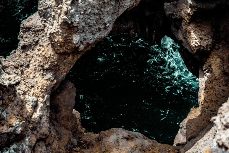 an image looking out from inside a cave