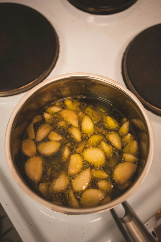 cooked potatoes in a pan on top of the stove