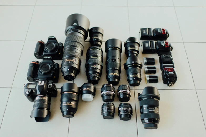 several lenses are shown next to camera parts