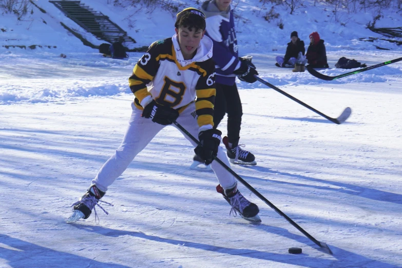 two men wearing yellow and black playing in snow