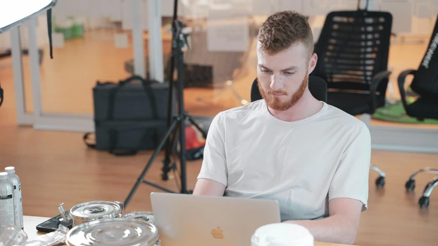man on his laptop in the studio with another camera