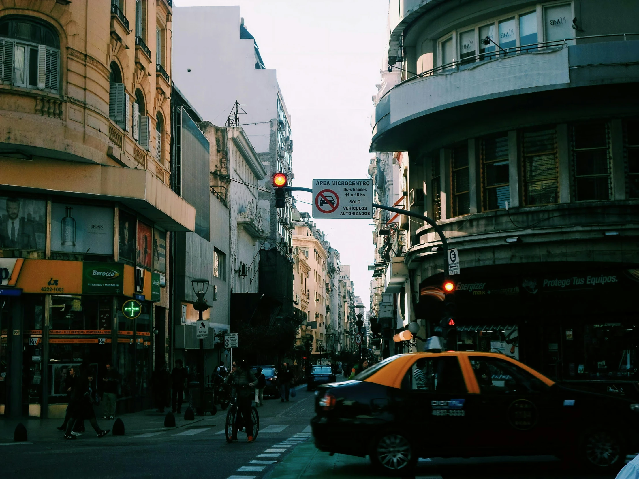 a busy city street with pedestrians and traffic on it