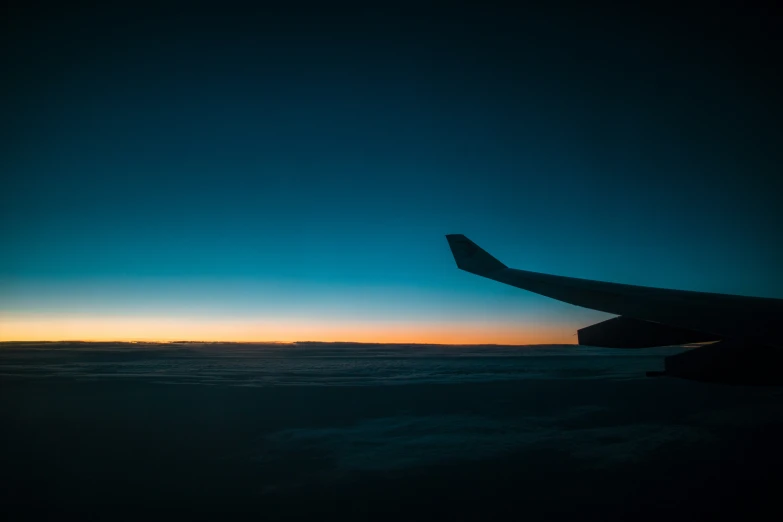 a large airplane wing flying high in the air